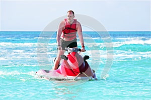 Young guy cruising on a jet ski