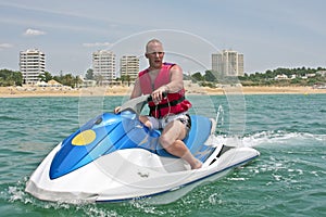 Young guy cruising on a jet ski