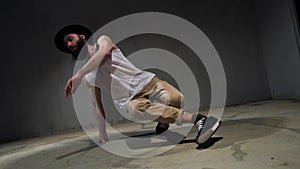 Young guy dancing break, urban style street breakdancing concept. Dancer jumps, motion, movement and emotion. Male