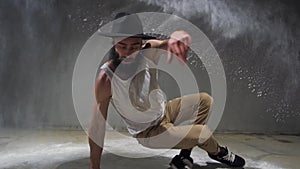 Young guy dancing break, urban style street breakdancing concept. Dancer jumps, motion, movement and emotion. Male