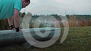 A Young Guy Does Push-Ups In The Early Morning In Nature Behind Lake Or A Quarry