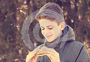 Young guy eating a cheeseburger