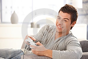 Young guy enjoying computer game