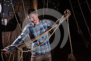 Young guy freed from captivity and selecting from ropes