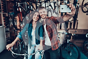 Young Guy and Girl Make Selfie at Bicycle Store