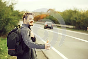 Young guy hitchhiking autostop