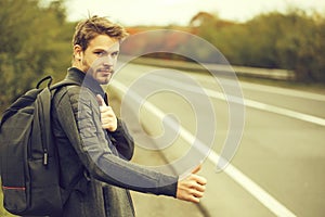 Young guy hitchhiking autostop