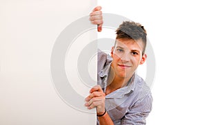 young guy holding blank billboard