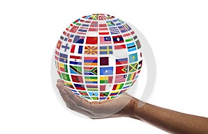 Young guy holding globe made of international flags, isolated on white, collage