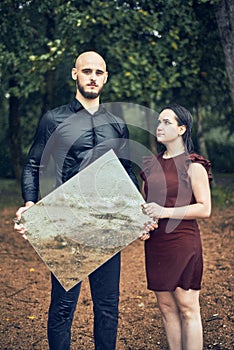 Young guy holds a mirror in the forest in the rain. a girl is reflected in a mirror. concept of vomiting, love, feelings, soul