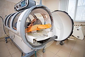 Young guy in a hyperbaric chamber, oxygen treatment