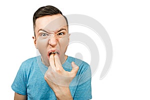 Young guy inserts two fingers in the mouth to induce vomiting, on a isolated white background photo