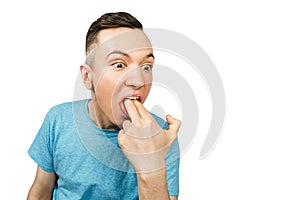 Young guy inserts two fingers in the mouth to induce vomiting, on a isolated white background