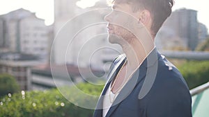 young guy in a jacket on the background of the city