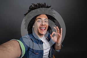 Young guy making selfie and looking excited