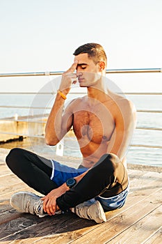 Young guy meditates and does breathing practice