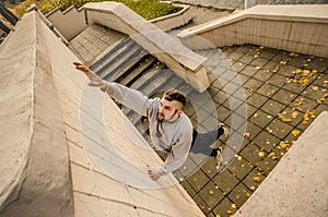 A young guy overcomes obstacles, climbing on concrete walls photo