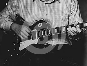 A young guy playing blues on an electric guitar. close-up.