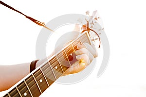 The young guy playing guitar in high-key