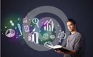 Young guy reading a book with business icons