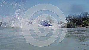 A young guy is riding a hydrocycle on the lake