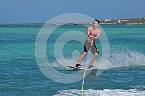 Young Guy Riding a Wakeboard Off the Coast of Aruba