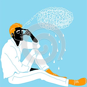 A young guy is sitting and holding his head with his hand meditating. Sadness, depression and thoughts. The concept of