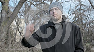 Young guy smokes at a park