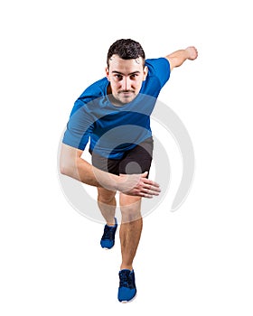 Young guy sprinter wearing black and blue sport equipment waiting for the start