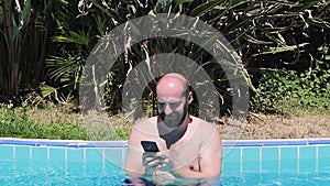 Young guy in sunglasses drink beverage making photo on his smartphone