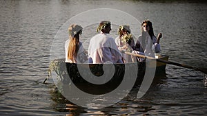 Young guy and three girls swimming in the boat
