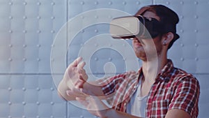 Young guy visualized virtual woman wearing virtual reality headset trying to adjust reality. Man touch virtual wall