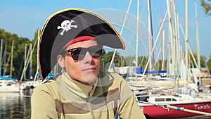 Young guy wearing silly cocked pirate hat, outdoor activities