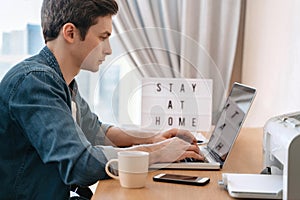 Young guy working remotely from home photo