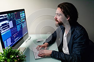 Young hacker in the dark breaks the access to steal information and infect computers and systems. concept of hacking and cyber