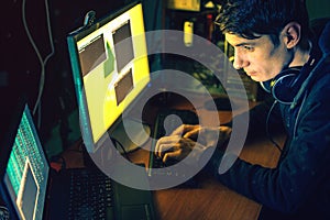 Young hacker in the dark infect computers and systems