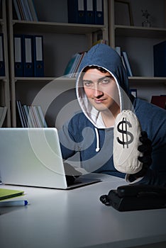 The young hacker hacking into computer at night