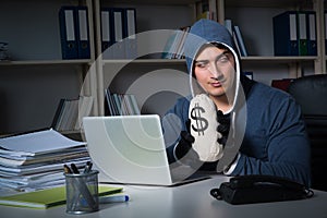 The young hacker hacking into computer at night