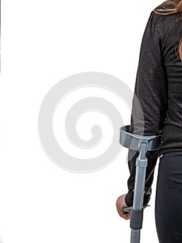 A young handicapped girl walking with crutches.