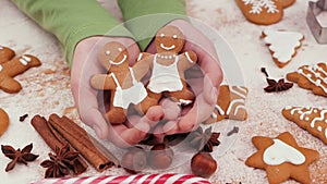 Young hands holding gingerbread people christmas cookies