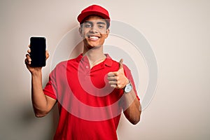 Young handsome african american delivery man holding smartphone showing screen app happy with big smile doing ok sign, thumb up