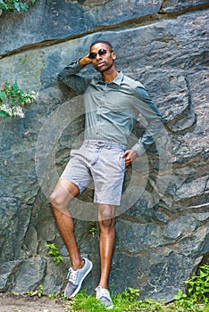 Young Handsome African American Man relaxing outside in park