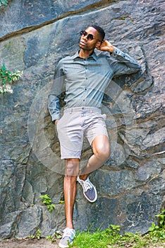 Young Handsome African American Man relaxing outside in park