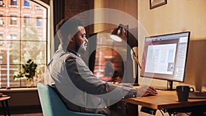 Young Handsome African American Man Working from Home on Desktop Computer in Sunny Stylish Loft