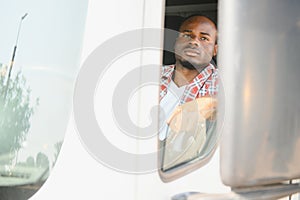 Young handsome African American man working in towing service and driving his truck.