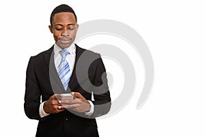 Young handsome African businessman using mobile phone