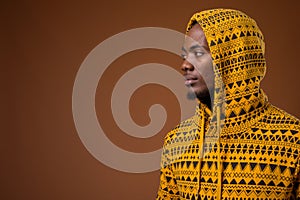 Young handsome African man against brown background