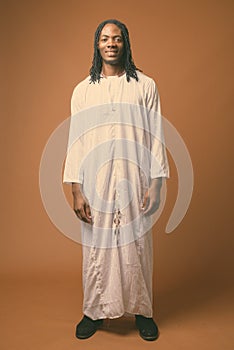 Young handsome African man wearing traditional clothes in black and white