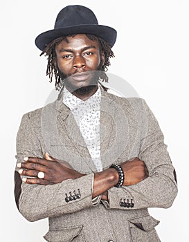 Young handsome afro american boy in stylish hipster hat gesturing emotional isolated on white background smiling