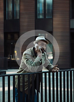 Young handsome Afro American man smiling and talking on cell phone on the street.